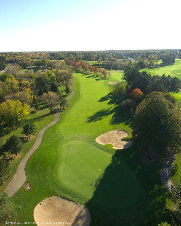 Aerial view of Hole 1 green and fairway with single sand trap and trees lining the straight-shot fairway