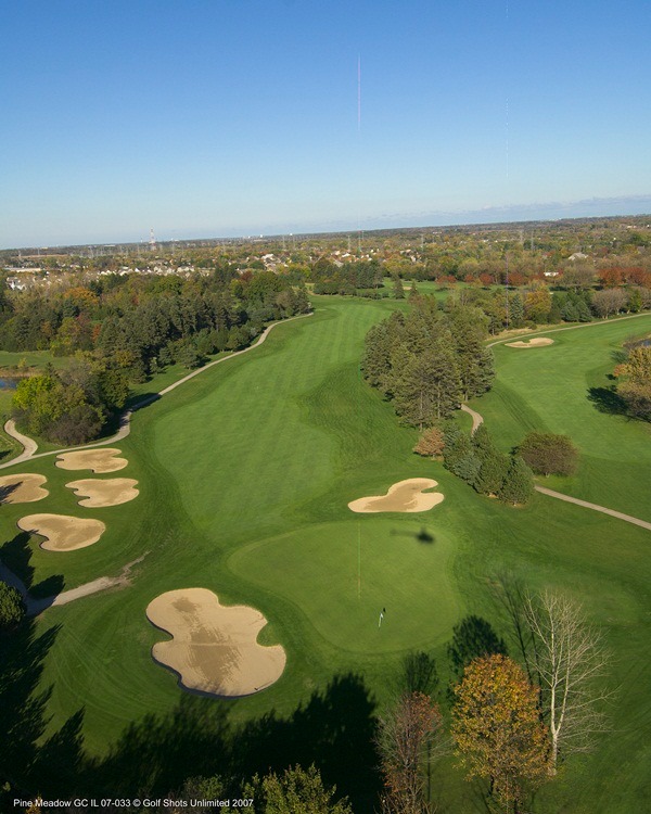 Aerial view of Hole 2 green and two sand traps and wide, tree-lined fairway