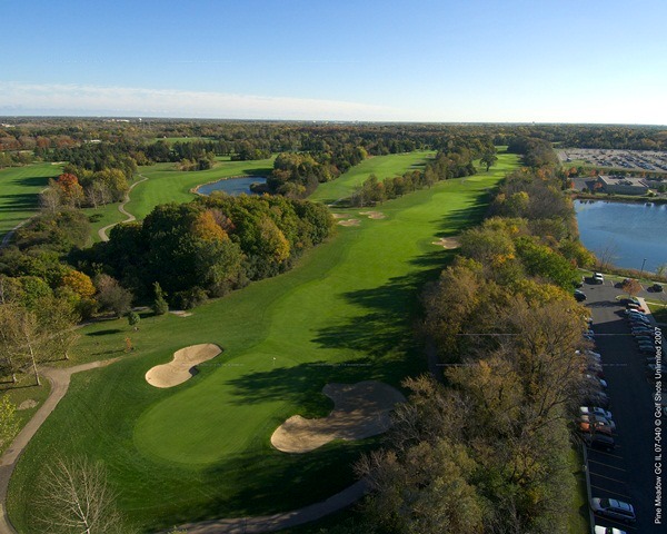 Aerial view of Hole 6 green and long, tree-lined fairway