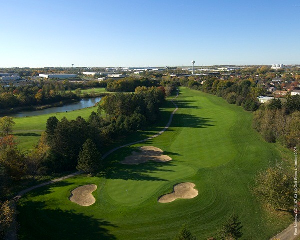 Aerial view of Hole 7 green and long, tree-lined fairway