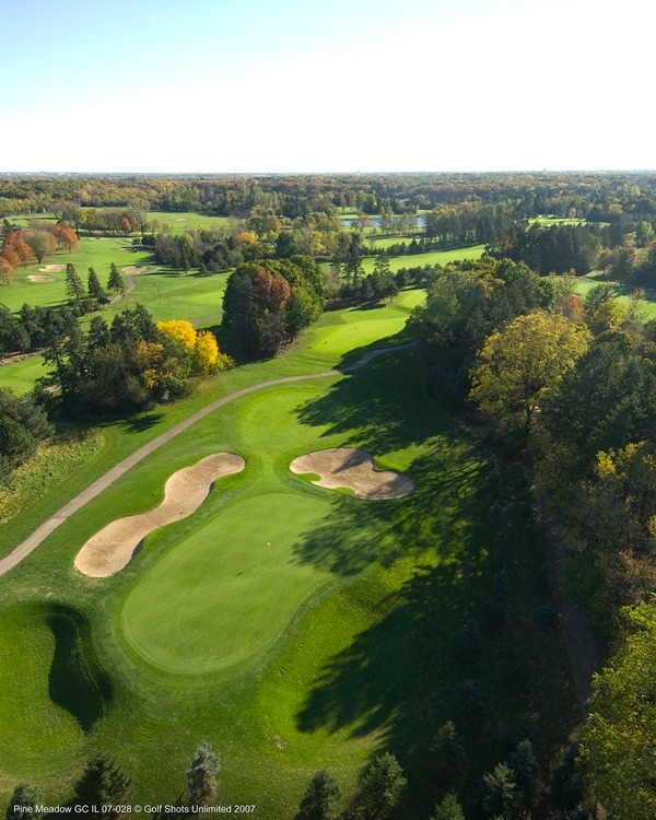 Aerial view of Hole 8 with sand traps and dense tree coverage on one side